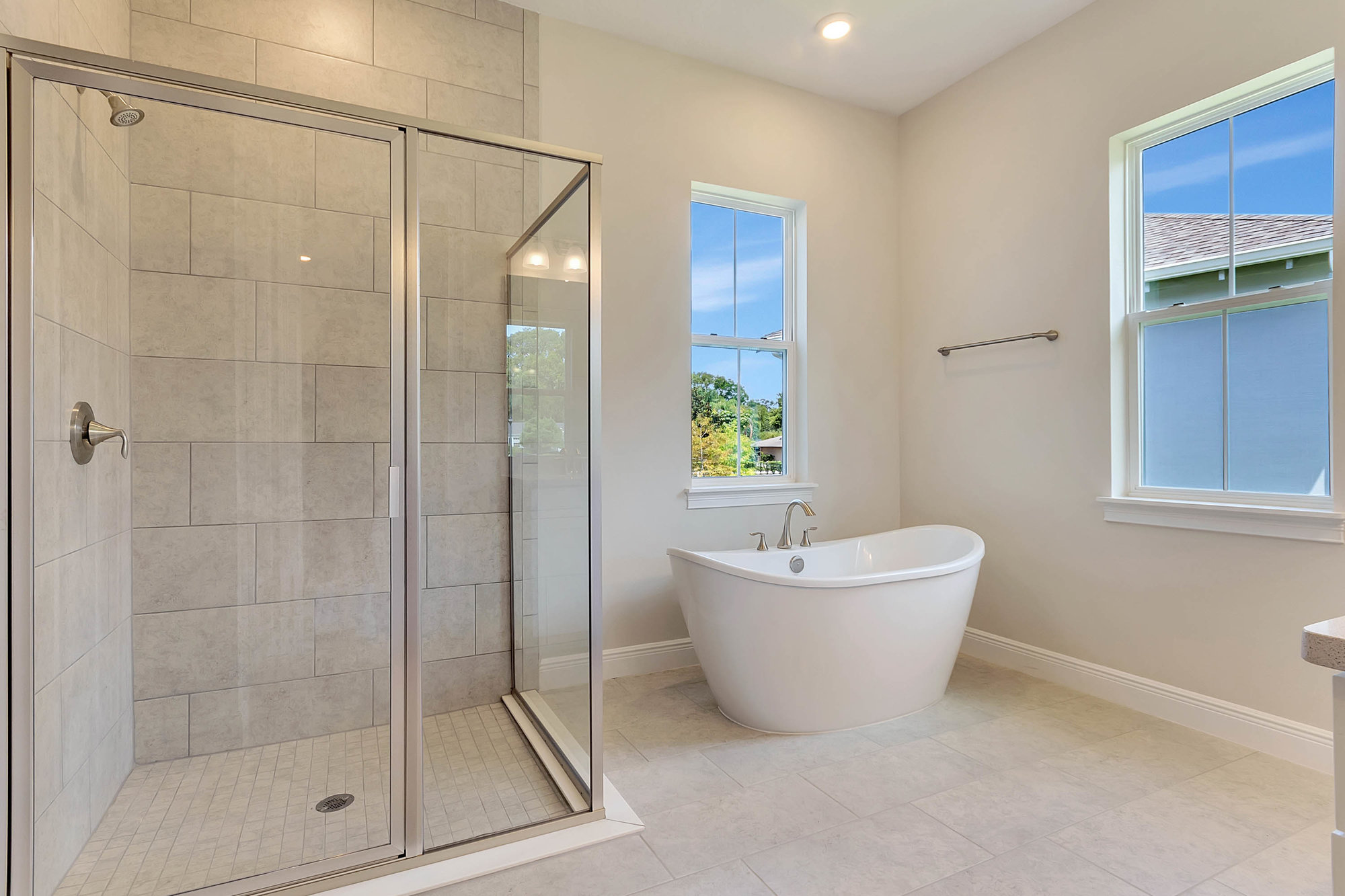 modern bathroom with white soaking tub and walk in shower